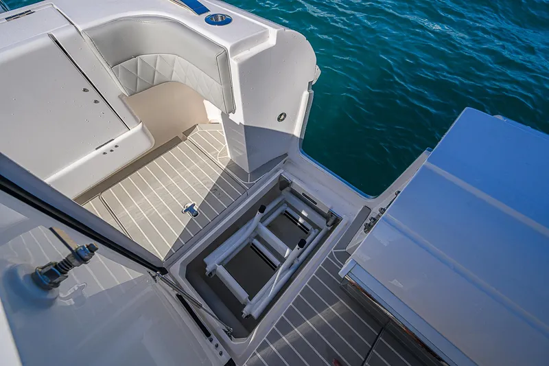  Yacht Photos Pics Intrepid 407 Cuddy 2020 boat interior with open hatch and seating, near water.