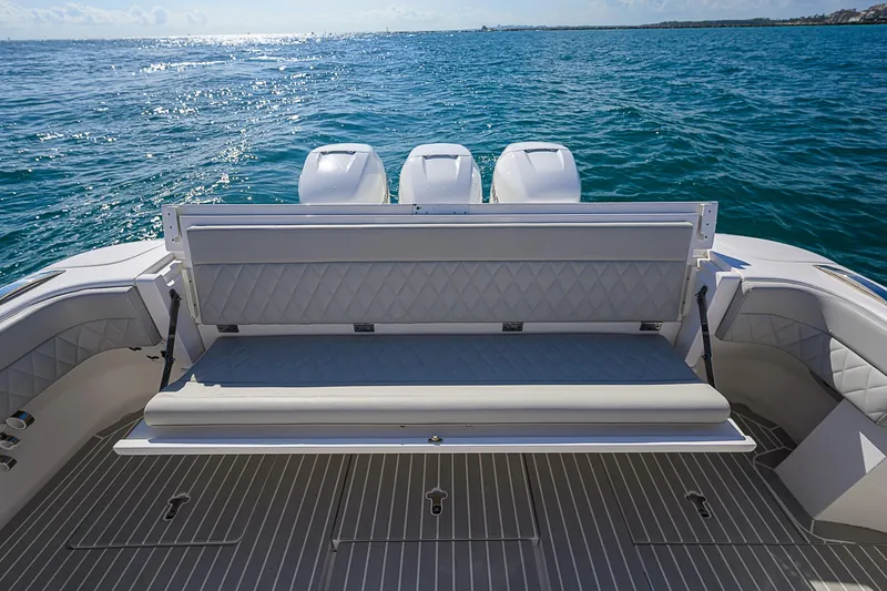  Yacht Photos Pics Intrepid 407 Cuddy 2020 boat with cushioned seating and triple engines on open water.