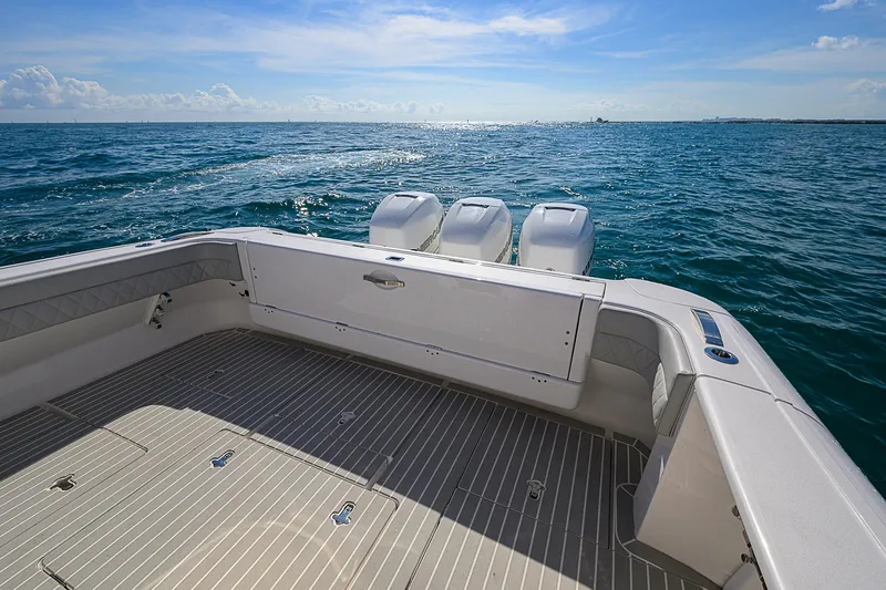  Yacht Photos Pics Intrepid 407 Cuddy 2020 boat on open sea, showcasing spacious deck and triple engines.