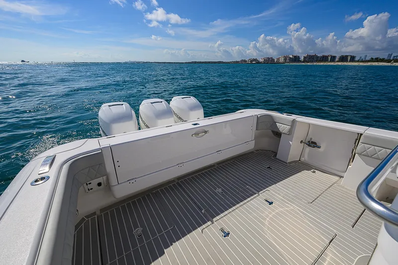  Yacht Photos Pics 2020 Intrepid 407 Cuddy boat on open water, featuring spacious deck and triple engines.