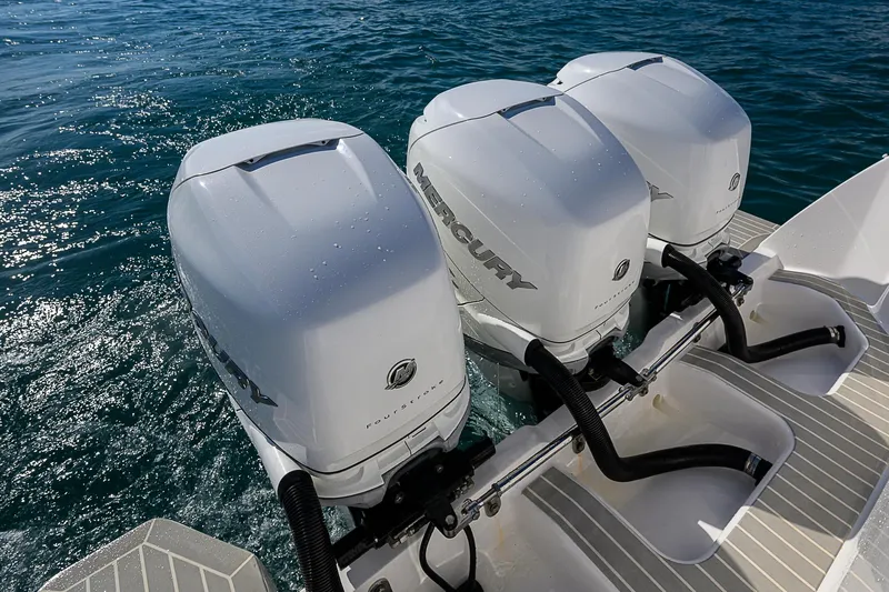  Yacht Photos Pics Triple Mercury outboard engines on 2020 Intrepid 407 Cuddy in clear blue water.
