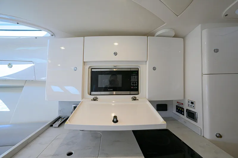 Yacht Photos Pics Modern kitchen area in 2020 Intrepid 407 Cuddy boat with microwave and sleek cabinetry.