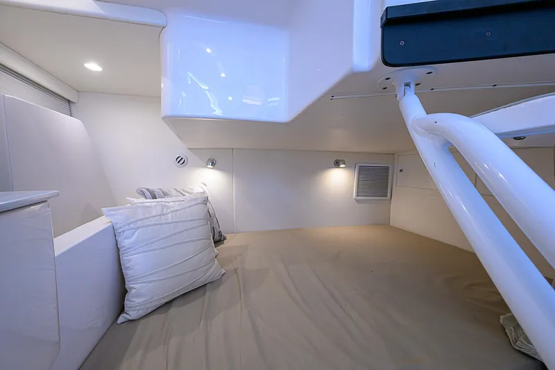  Yacht Photos Pics Interior cabin of 2020 Intrepid 407 Cuddy with cozy bedding and modern lighting.
