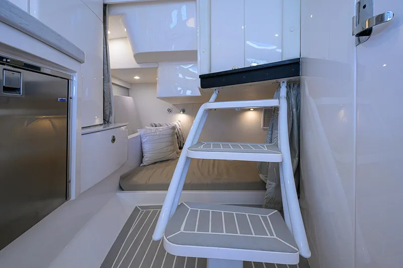  Yacht Photos Pics Interior of 2020 Intrepid 407 Cuddy, featuring modern design and cozy sleeping area.