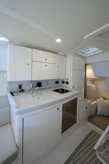  Yacht Photos Pics 2020 Intrepid 407 Cuddy interior with modern kitchenette and sleek design.