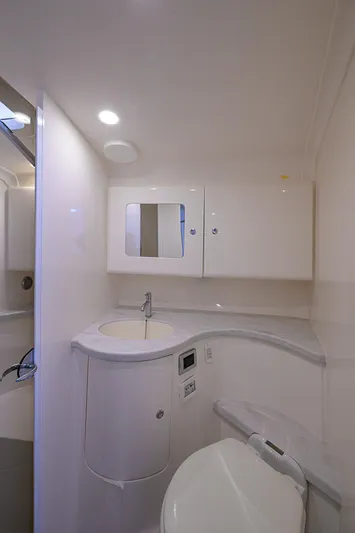  Yacht Photos Pics Modern bathroom in 2020 Intrepid 407 Cuddy boat, featuring sleek design and compact amenities.
