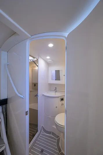  Yacht Photos Pics 2020 Intrepid 407 Cuddy boat bathroom interior with modern fixtures and lighting.