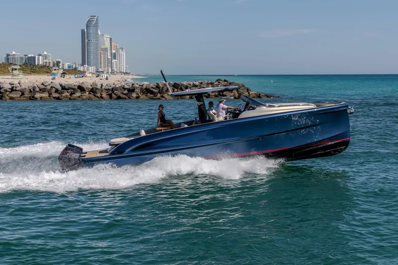 40f Open O/b Yacht Photos Pics 2024 Solaris Power SP 40F Open yacht cruising near a coastal city skyline.