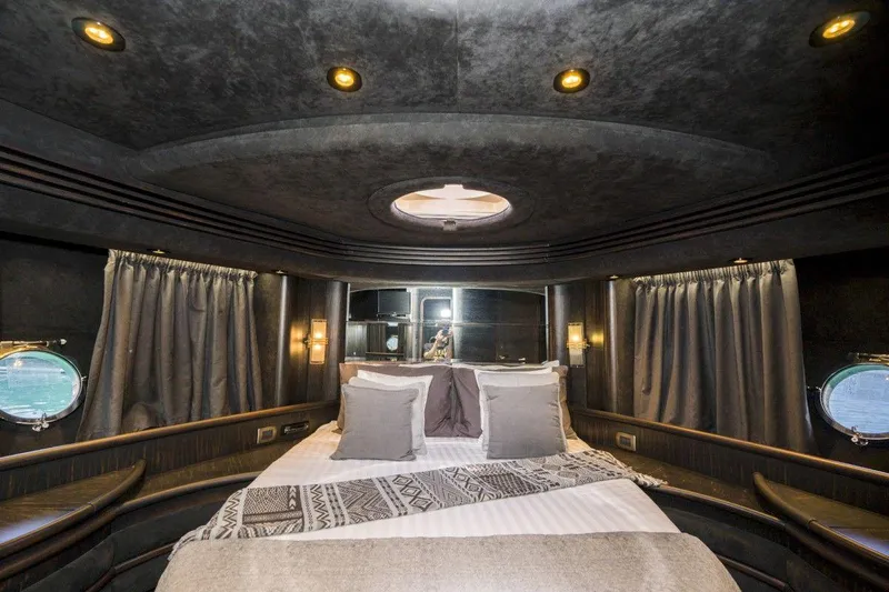  Yacht Photos Pics Luxurious interior of a 2005 Azimut 68 yacht cabin with elegant bedding and ambient lighting.