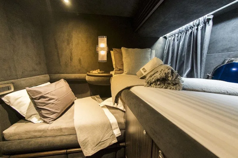  Yacht Photos Pics Luxurious bedroom interior of a 2005 Azimut 68 yacht, featuring plush bedding and ambient lighting.