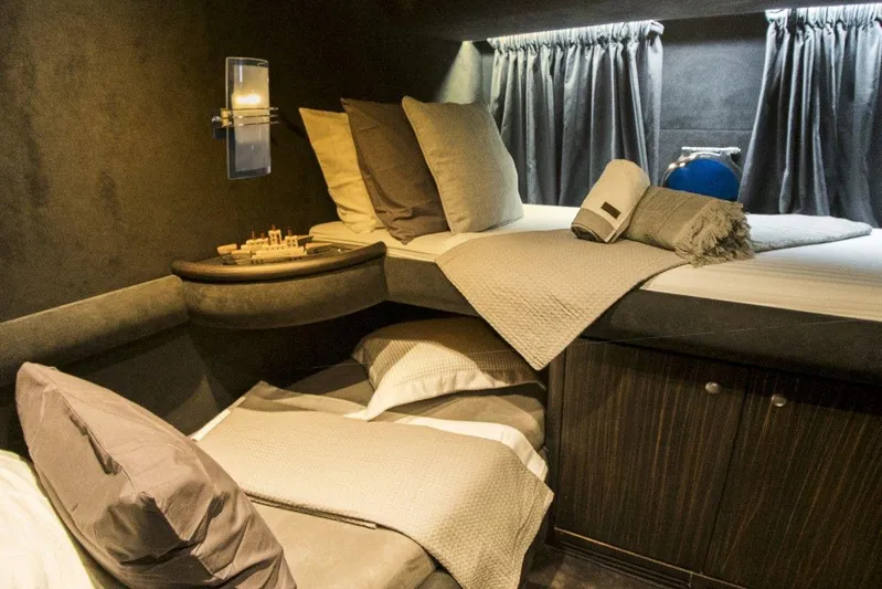  Yacht Photos Pics Luxurious cabin interior of a 2005 Azimut 68 yacht with cozy bedding and ambient lighting.