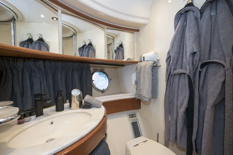  Yacht Photos Pics Luxurious bathroom interior of 2005 Azimut 68 yacht with robes and elegant fixtures.