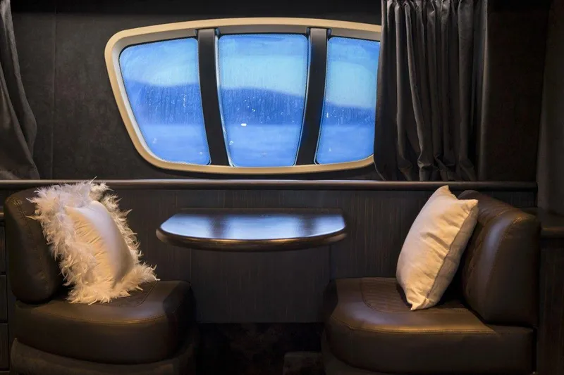  Yacht Photos Pics Luxurious interior of 2005 Azimut 68 yacht with elegant seating and window view.