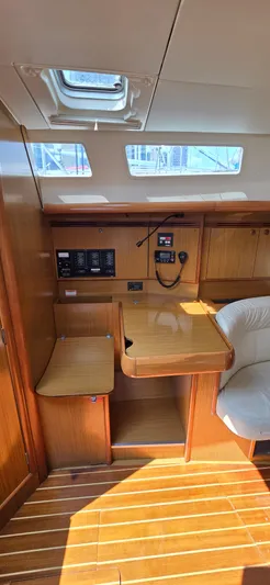 Cherish The Day Yacht Photos Pics Interior of 2006 Jeanneau Sun Odyssey 40.3 sailboat with wooden finish and navigation station.