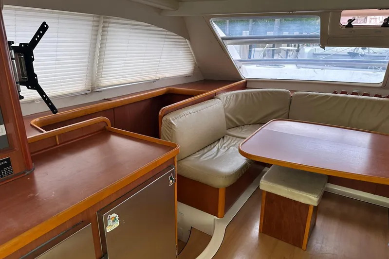 Yacht Photos Pics Interior of 2011 Robertson & Caine Leopard 46 catamaran with dining area and seating.