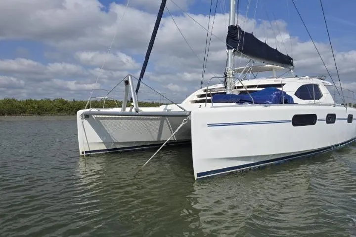  Yacht Photos Pics 2011 Robertson & Caine Leopard 46 catamaran sailing on calm waters under a blue sky.