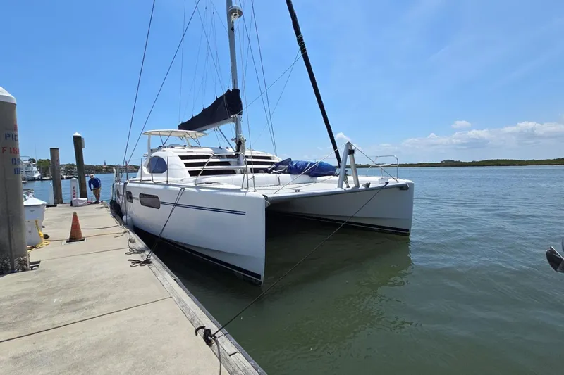  Yacht Photos Pics 2011 Robertson & Caine Leopard 46 catamaran docked at a marina under clear skies.