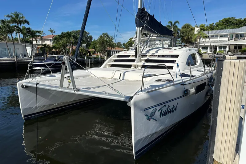  Yacht Photos Pics 2011 Robertson & Caine Leopard 46 catamaran docked in a sunny marina setting.