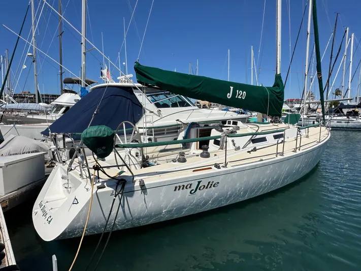 Ma Jolie Yacht Photos Pics Sailboat J/120 from 1996 docked in marina, featuring green sail cover.