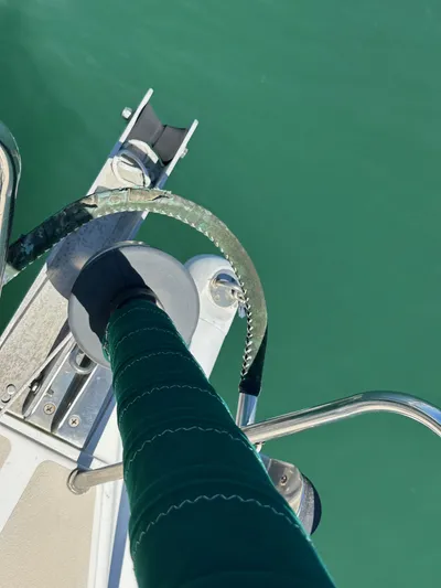 Ma Jolie Yacht Photos Pics Close-up of a 1996 J Boats J/120 sailboat deck with green water background.