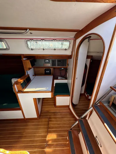 Ma Jolie Yacht Photos Pics Interior of 1996 J Boats J/120 sailboat with wood finish and compact dining area.