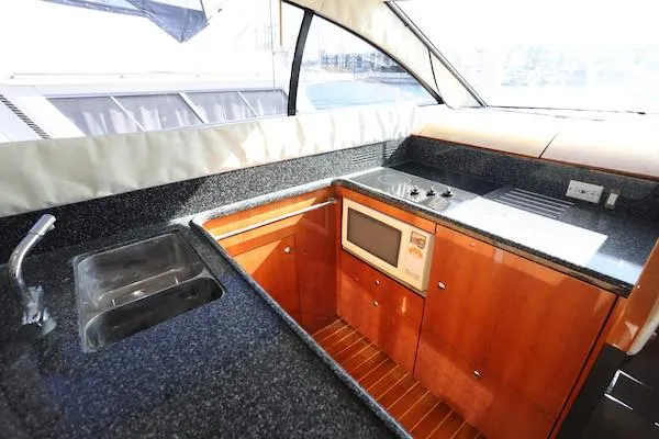Coastal Pioneer Yacht Photos Pics Luxurious kitchen area in 2002 Fairline Phantom 50 yacht with modern amenities.
