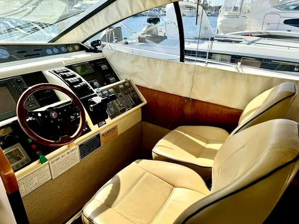 Coastal Pioneer Yacht Photos Pics Interior cockpit of 2002 Fairline Phantom 50 yacht with leather seats and control panel.