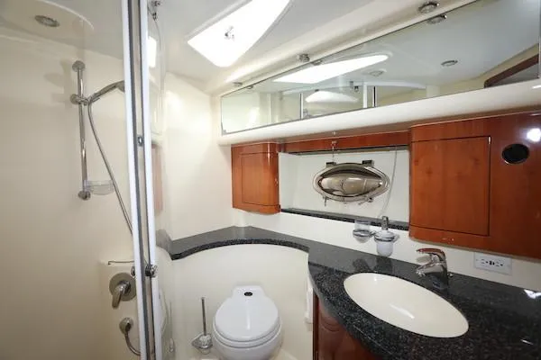 Coastal Pioneer Yacht Photos Pics Luxurious bathroom in 2002 Fairline Phantom 50 yacht with modern fixtures and wood cabinetry.