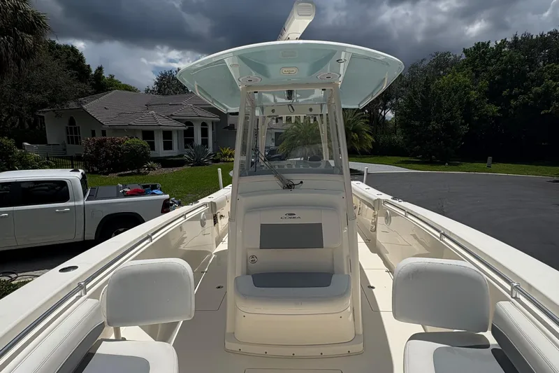 Joe Yacht Photos Pics 2018 Cobia 301 Center Console boat parked in residential driveway under cloudy sky.