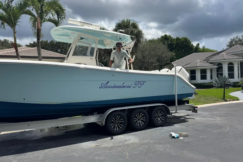 Joe Yacht Photos Pics 2018 Cobia 301 Center Console boat on trailer in residential driveway.