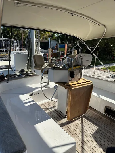 Unexpected Pleasure Yacht Photos Pics 1985 Nautical Development 56 sailboat cockpit with steering wheel and wooden accents.