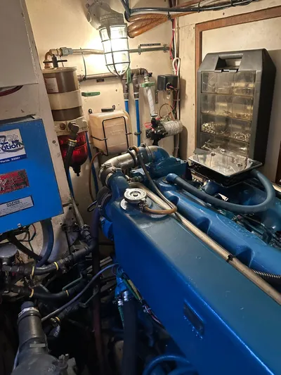 Unexpected Pleasure Yacht Photos Pics Engine room of a 1985 Nautical Development 56 yacht, featuring complex machinery and wiring.