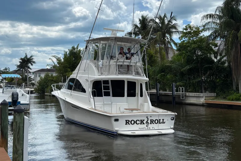 Rock & Roll Yacht Photos Pics 2008 Ocean 42 Super Sport Convertible yacht in a scenic canal setting.
