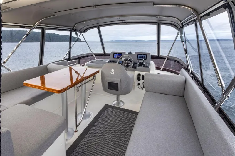 4 My Valentine Yacht Photos Pics Interior of 2022 Beneteau Swift Trawler 41, featuring helm, seating, and ocean view.