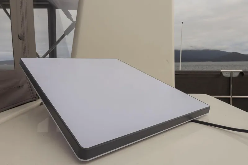 4 My Valentine Yacht Photos Pics Satellite dish on 2022 Beneteau Swift Trawler 41, with ocean and mountains in background.