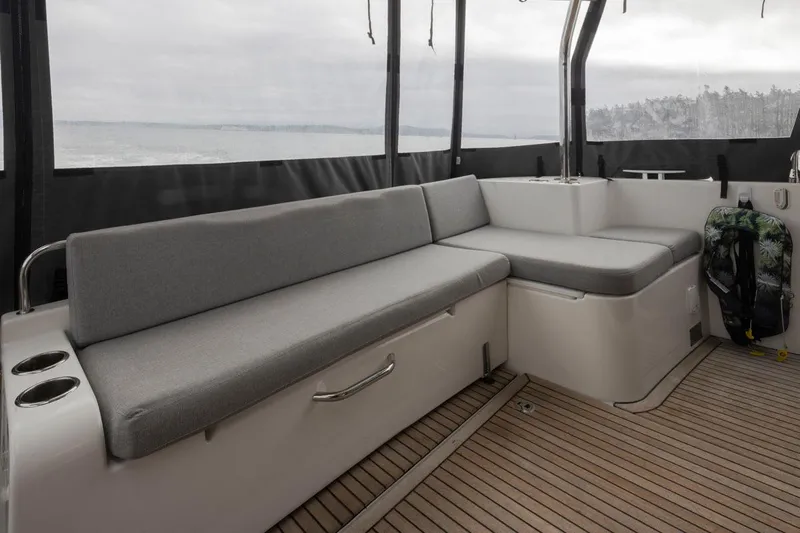 4 My Valentine Yacht Photos Pics Interior of 2022 Beneteau Swift Trawler 41 with gray seating and wooden flooring.