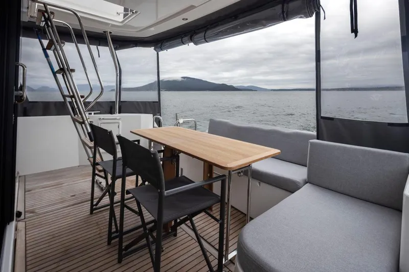 4 My Valentine Yacht Photos Pics 2022 Beneteau Swift Trawler 41 aft deck with seating, table, and ocean view.