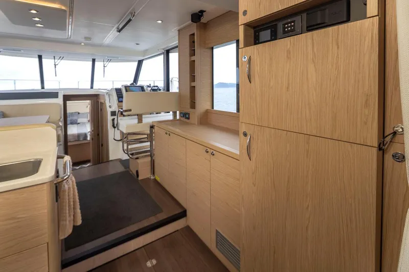 4 My Valentine Yacht Photos Pics Interior of 2022 Beneteau Swift Trawler 41, featuring modern wood cabinetry and helm station.
