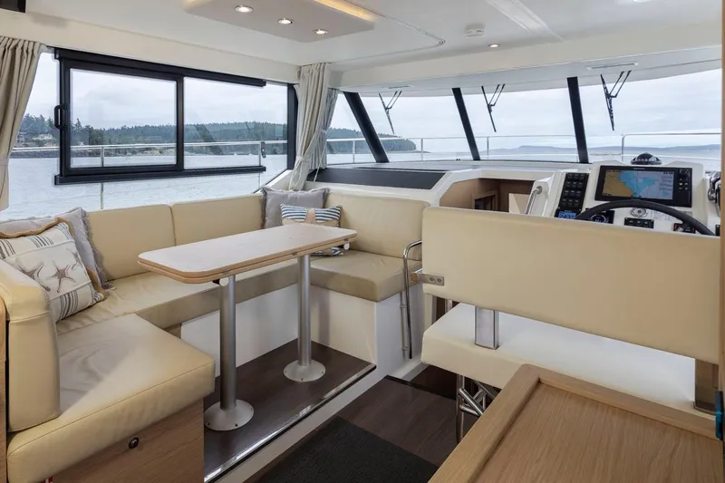 4 My Valentine Yacht Photos Pics Interior of 2022 Beneteau Swift Trawler 41 with beige seating and navigation equipment.