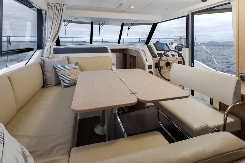 4 My Valentine Yacht Photos Pics Interior of 2022 Beneteau Swift Trawler 41, featuring a cozy seating area and navigation controls.