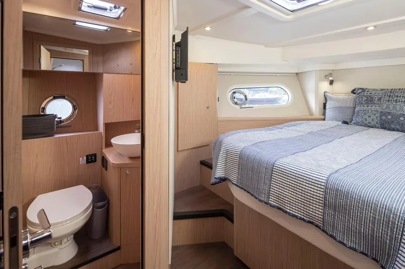 4 My Valentine Yacht Photos Pics 2022 Beneteau Swift Trawler 41 interior with cozy bedroom and modern bathroom.
