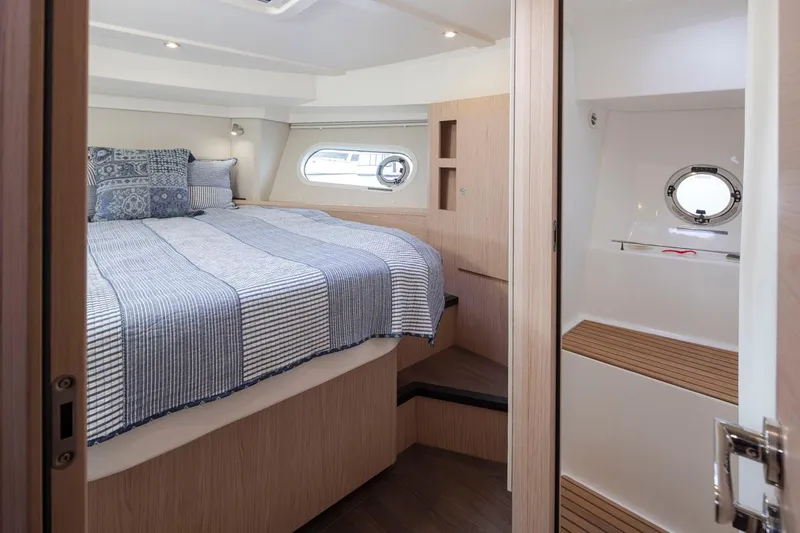 4 My Valentine Yacht Photos Pics Interior of 2022 Beneteau Swift Trawler 41, featuring cozy bedroom with nautical decor.