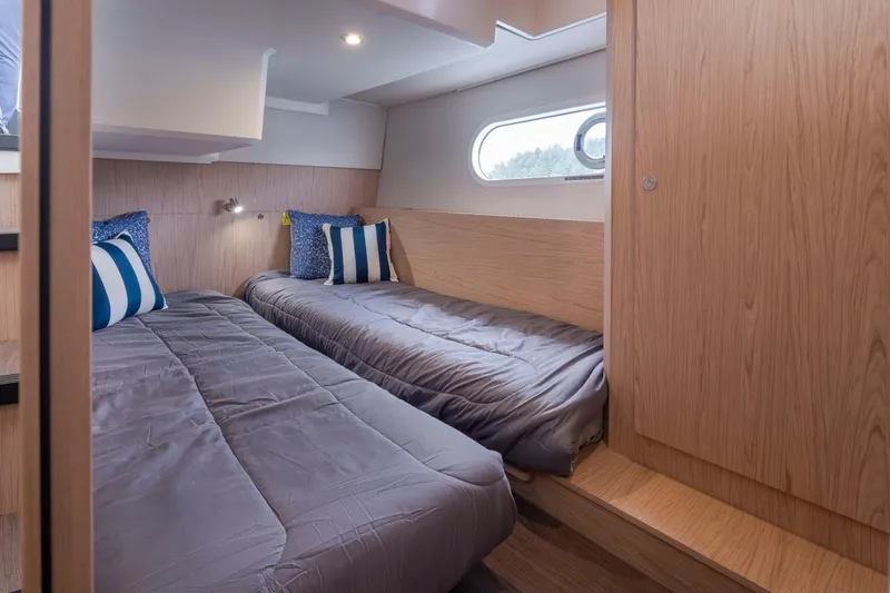 4 My Valentine Yacht Photos Pics Cabin interior of 2022 Beneteau Swift Trawler 41 with twin beds and modern decor.