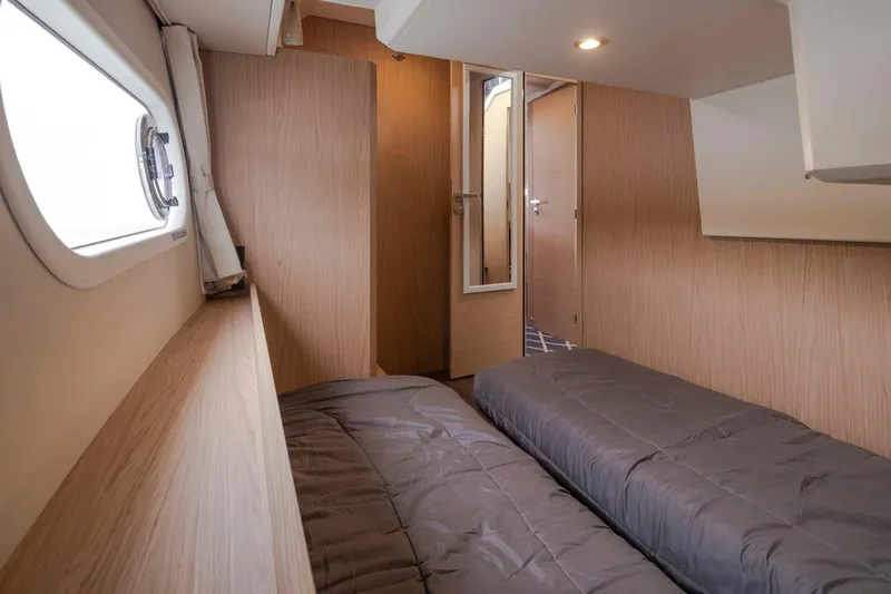 4 My Valentine Yacht Photos Pics 2022 Beneteau Swift Trawler 41 cabin interior with twin beds and wooden finish.