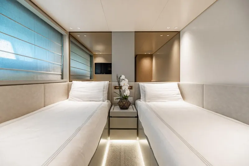 Legacy Yacht Photos Pics Luxurious twin cabin interior on 2022 Sanlorenzo SD96 yacht, featuring elegant decor and ambient lighting.
