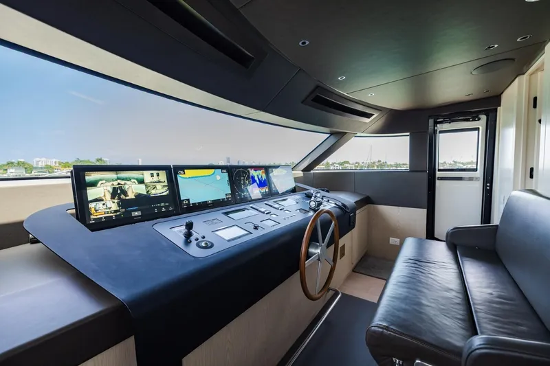 Legacy Yacht Photos Pics Luxurious 2022 Sanlorenzo SD96 yacht helm with advanced navigation displays and leather seating.