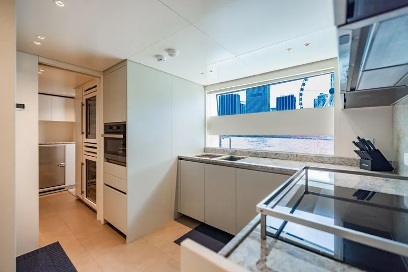 Legacy Yacht Photos Pics Modern kitchen interior on 2022 Sanlorenzo SD96 yacht with cityscape view.