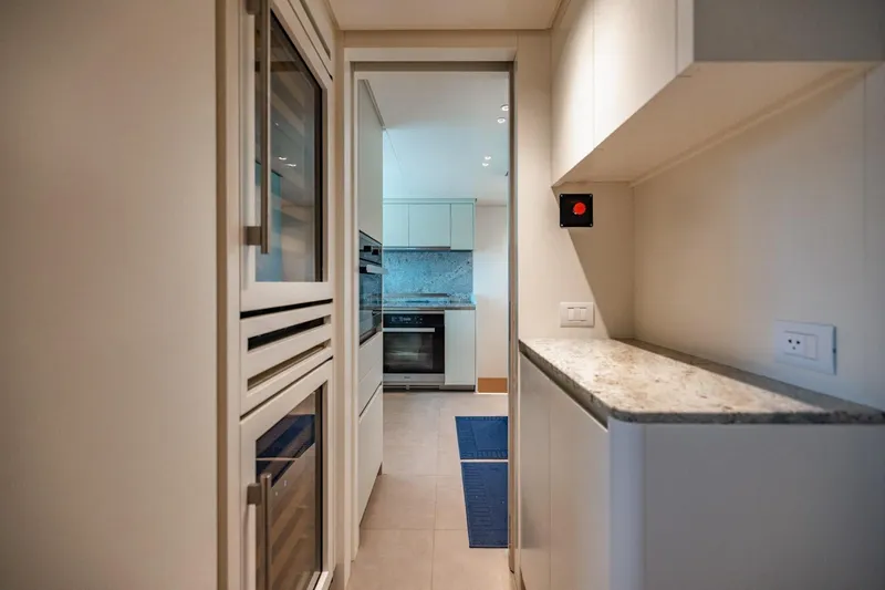 Legacy Yacht Photos Pics Modern kitchen interior on 2022 Sanlorenzo SD96 yacht, featuring sleek cabinetry and appliances.