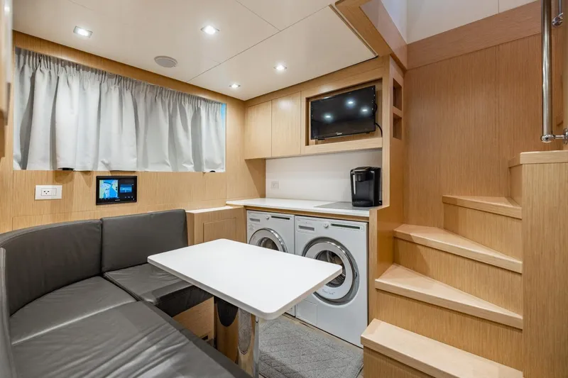 Legacy Yacht Photos Pics Modern interior of 2022 Sanlorenzo SD96 yacht with seating, appliances, and stairs.