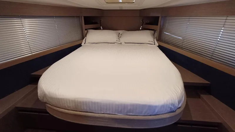  Yacht Photos Pics 2023 Beneteau Gran Turismo 41 yacht bedroom with a cozy double bed and modern design.